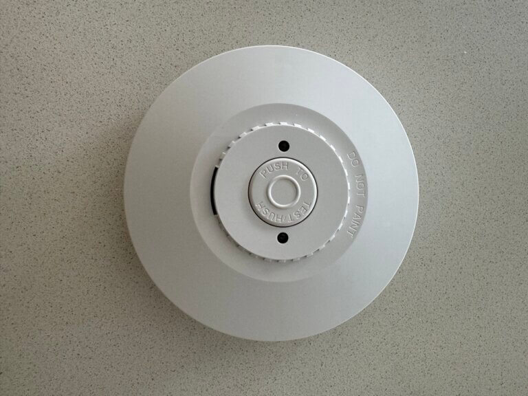 Mains-powered photoelectric smoke alarm installed on a Perth ceiling by Web X Electricians Perth